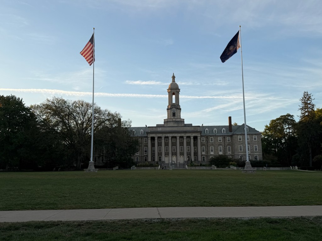 Ryan Abramson Director of Strategic Communications at Penn State University Lehigh Valley at a conference in State College, PA on the lawn in front of Old Main.