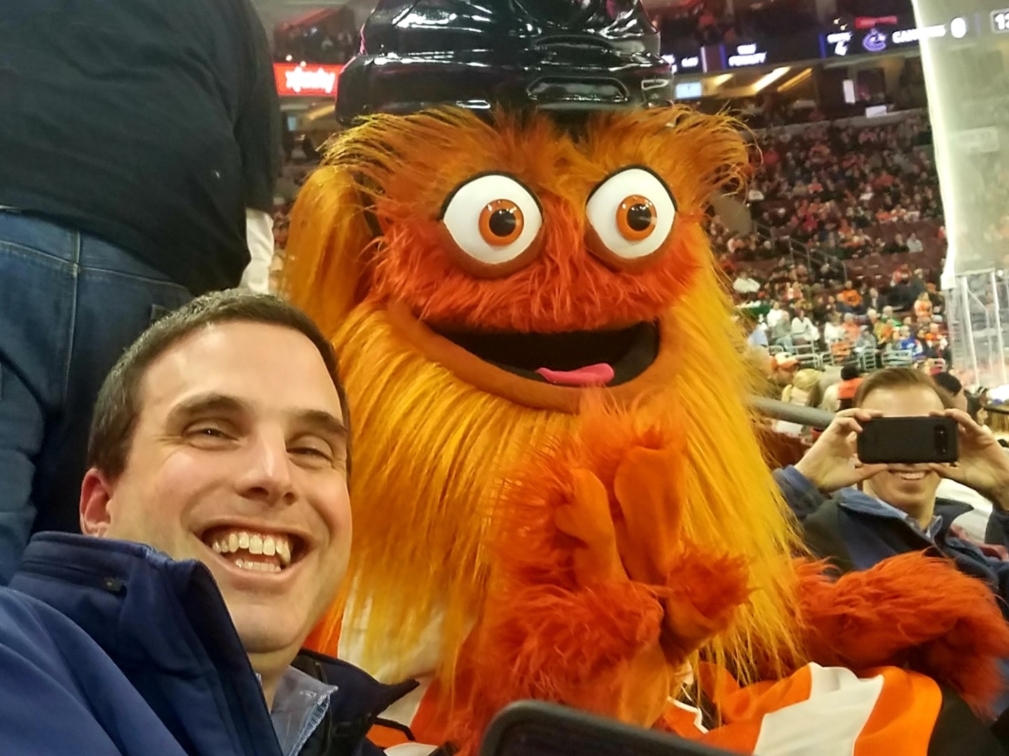 Ryan Abramson at the Xfinity mobile arena in Philadelphia with mascot Gritty